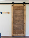 Refined Rustic barn door in a two tone finish, with Single Wheel Horseshoe soft close barn door hardware. As seen on Love It or List It Vacation.