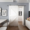 Stainless steel soft close barn door hardware mounted to the top of a white "K" style doors